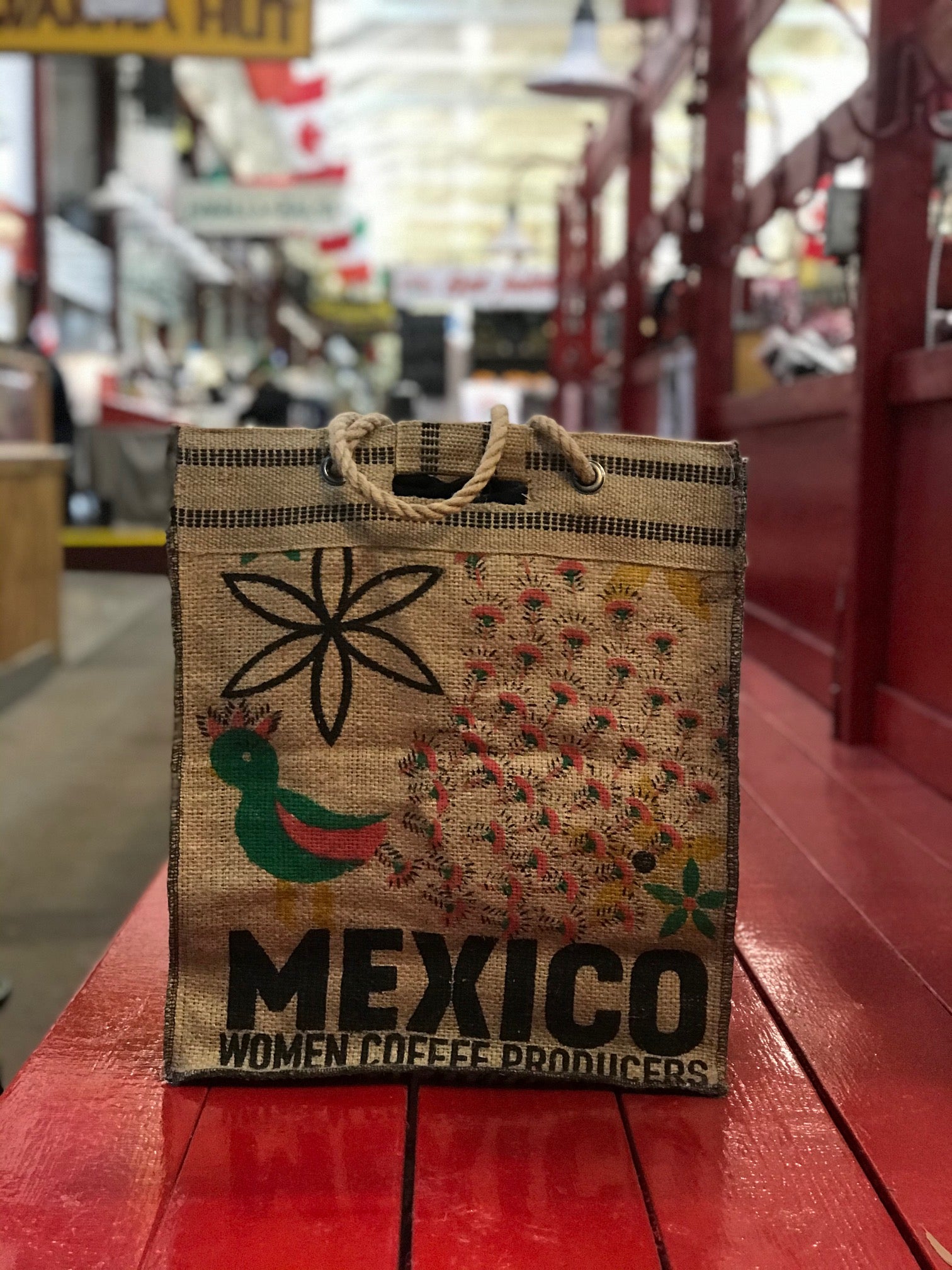 Custom Mexico coffee sack tote on a red bench