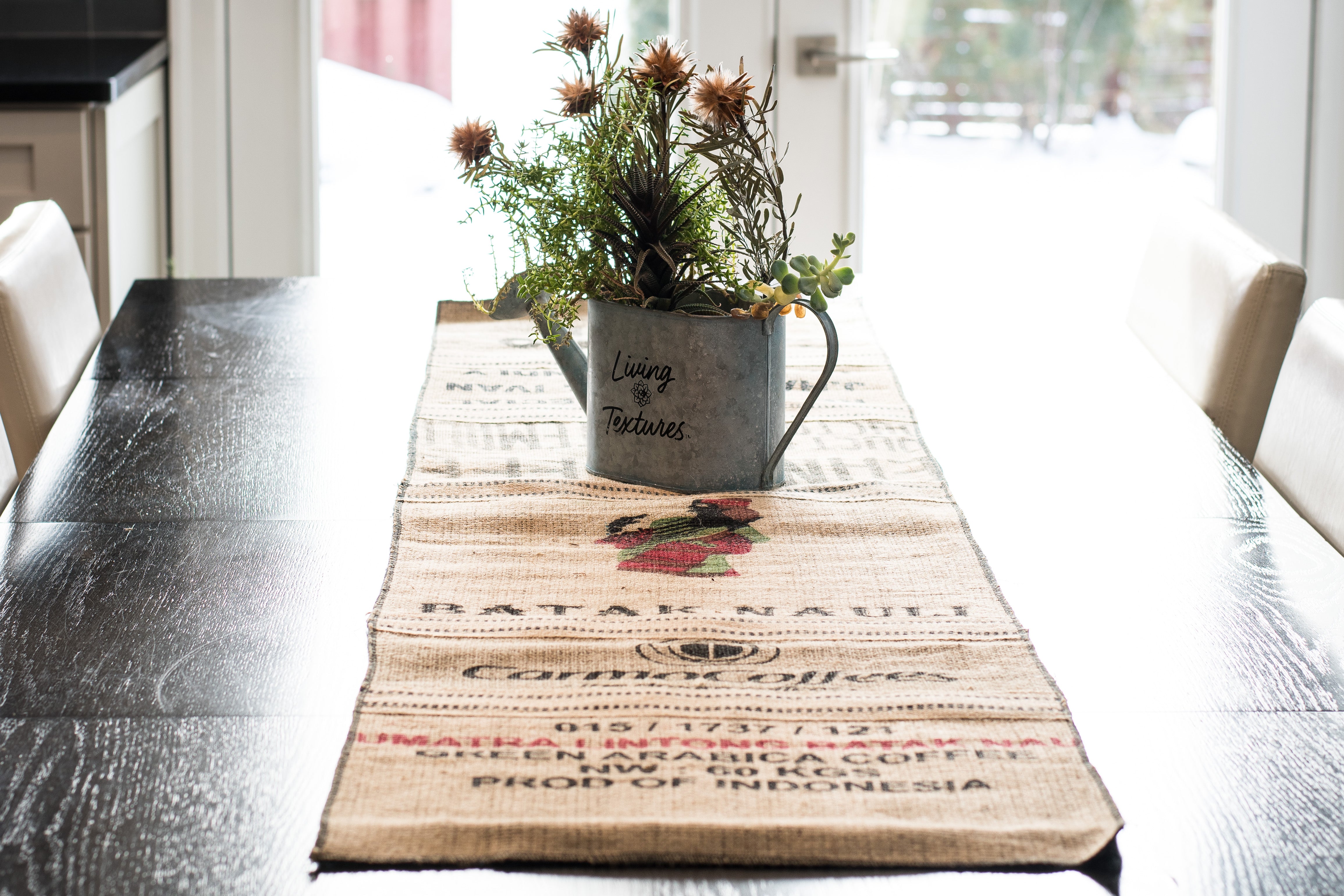 Coffee sack table runner on a dining table with a planter