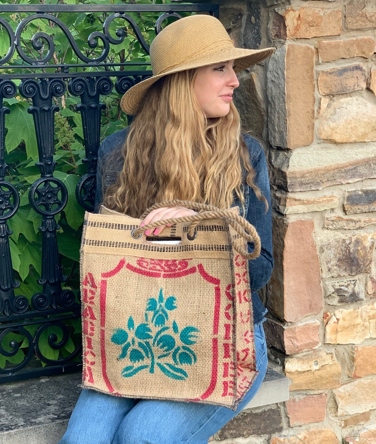 Custom floral coffee sack tote carried by a woman in a hat