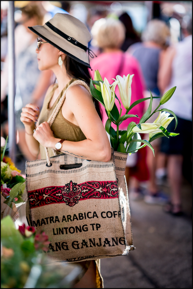 Custom coffee sack tote carried at a flower market